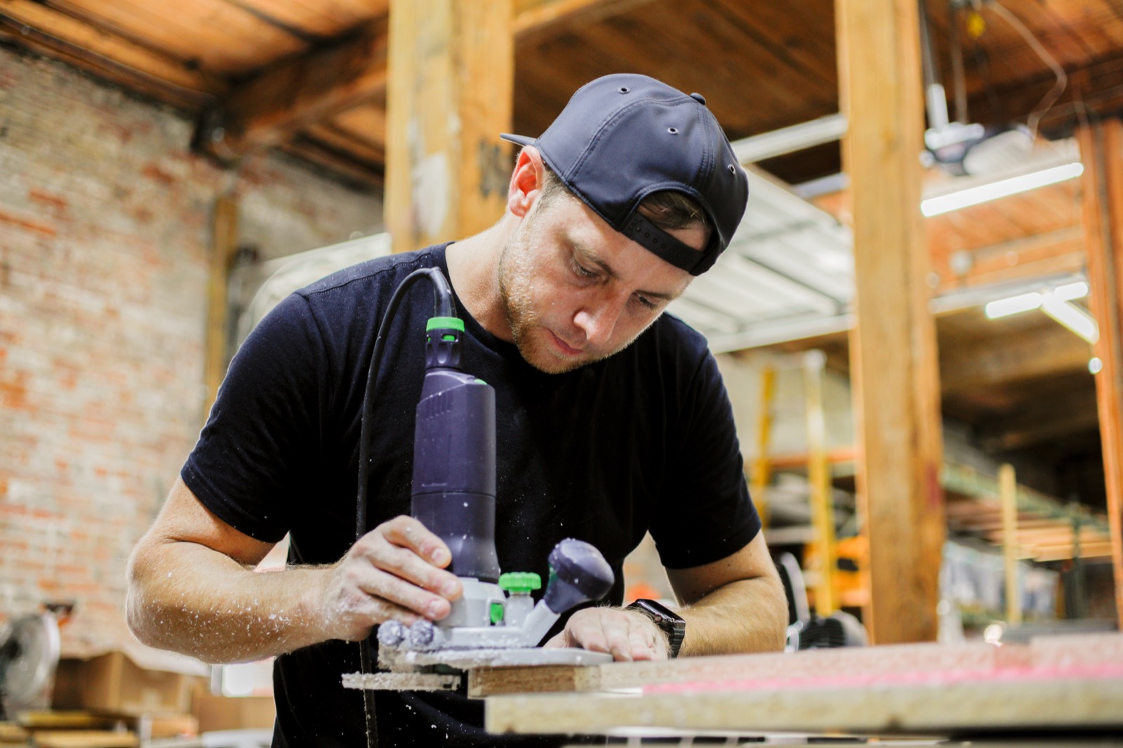 Kyle Buckner close-up routing wood with precision