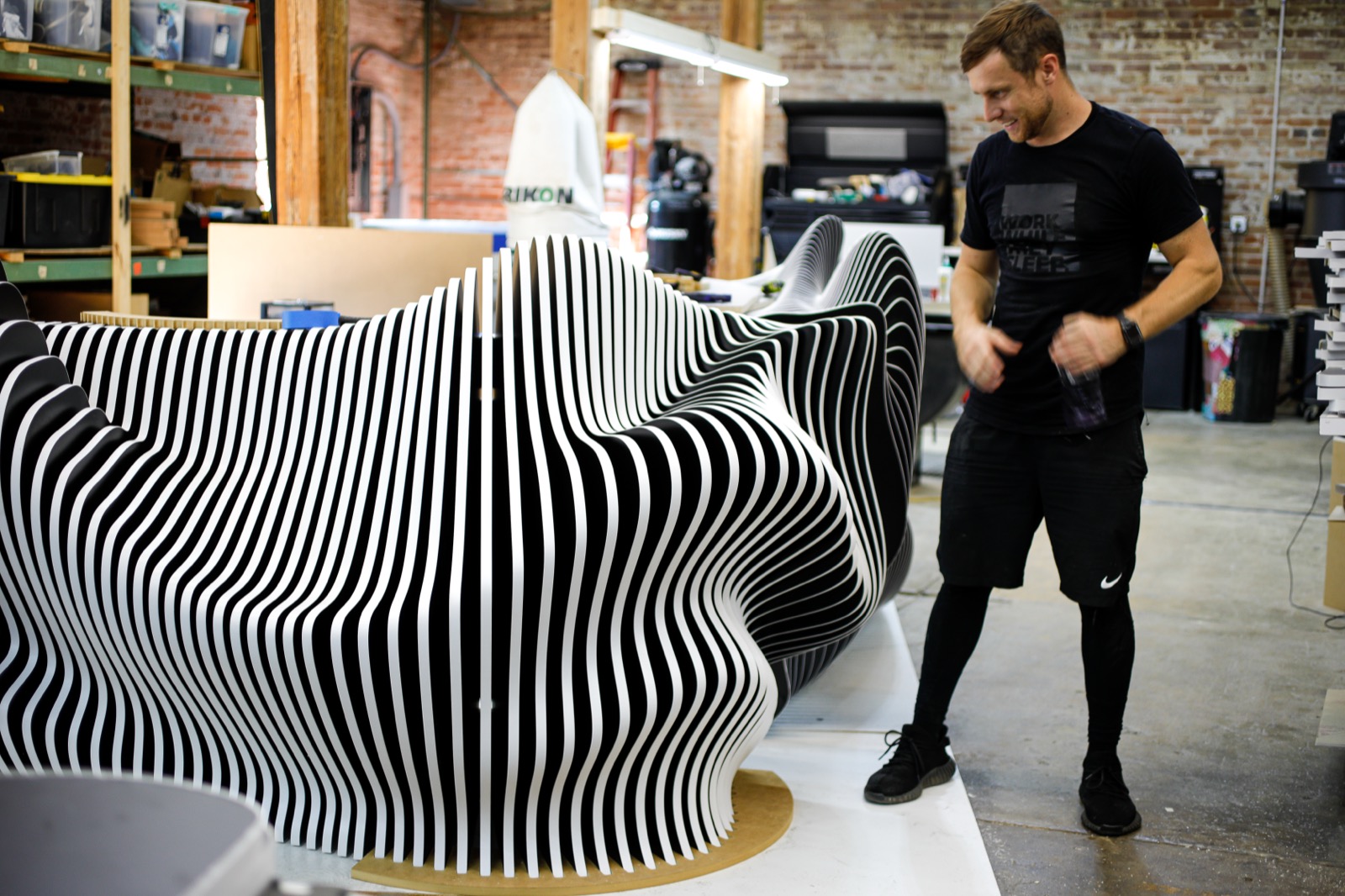 Kyle Buckner in his studio with a finished WAVES bench